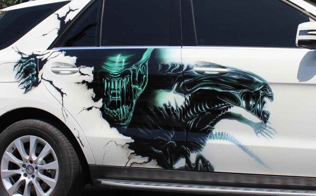 Custom airbrush art on car by Ira Cosmos